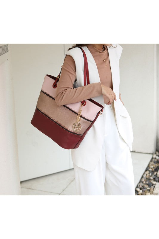 Colorblock tote bag with top zip, burgundy, tan, and blush panels; gold “M” charm
