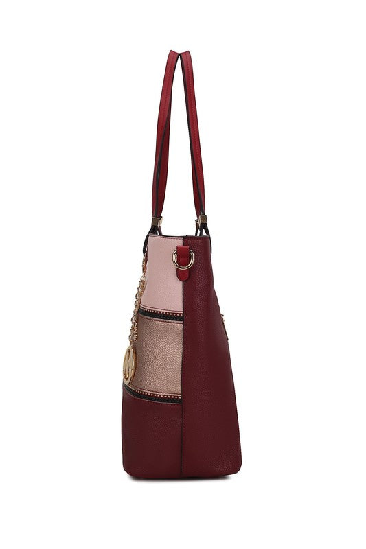 Side view of burgundy tote with blush color-block panel and adjustable top handles