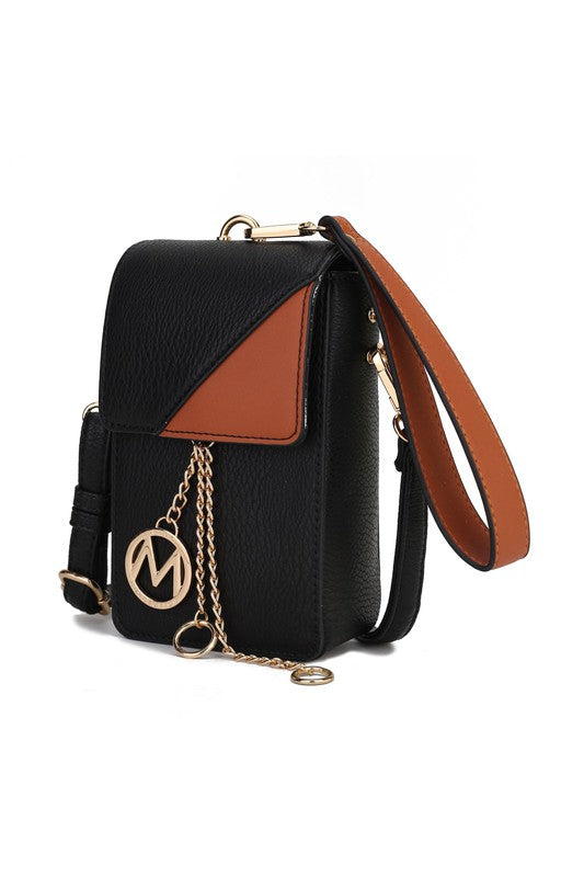 Black crossbody with tan/brown flap panel, circular logo charm, and gold chain strap.