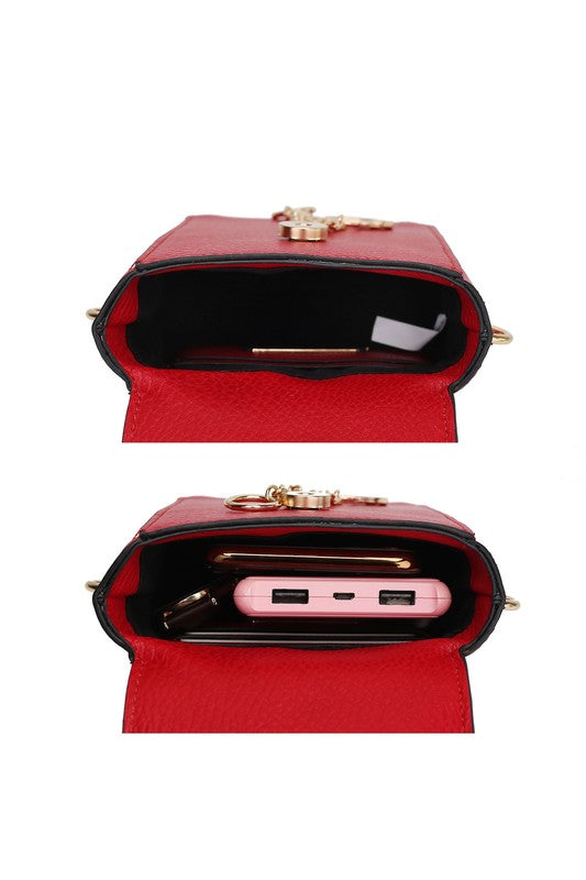 Red crossbody interior view: black lining and small card-slot panel with gold trim.