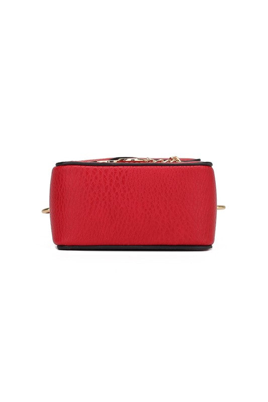Red crossbody bag bottom view with textured finish and small metal studs.