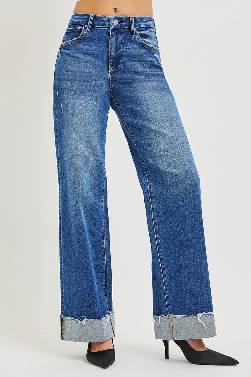 Medium wash blue high-rise wide-leg jeans with cuffed, frayed ankle hem