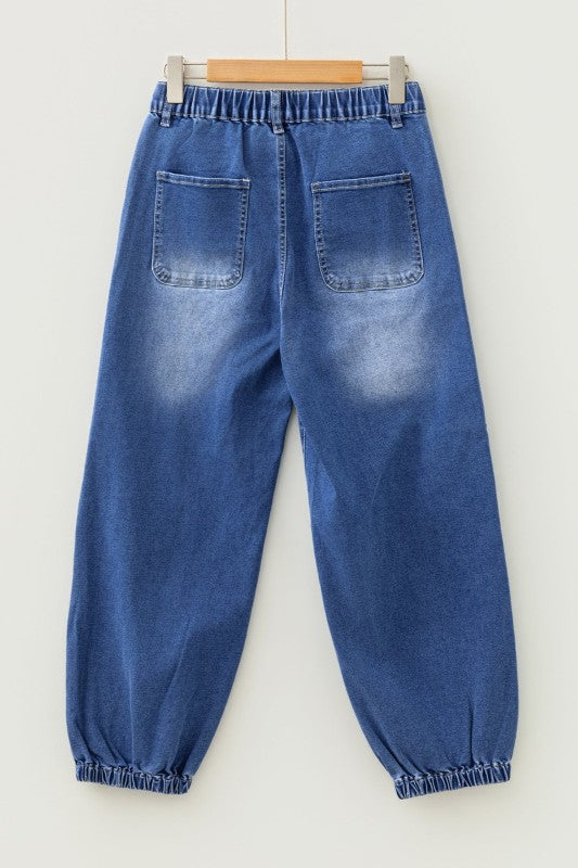 Blue denim jeans on hanger, elastic waistband and two front pockets