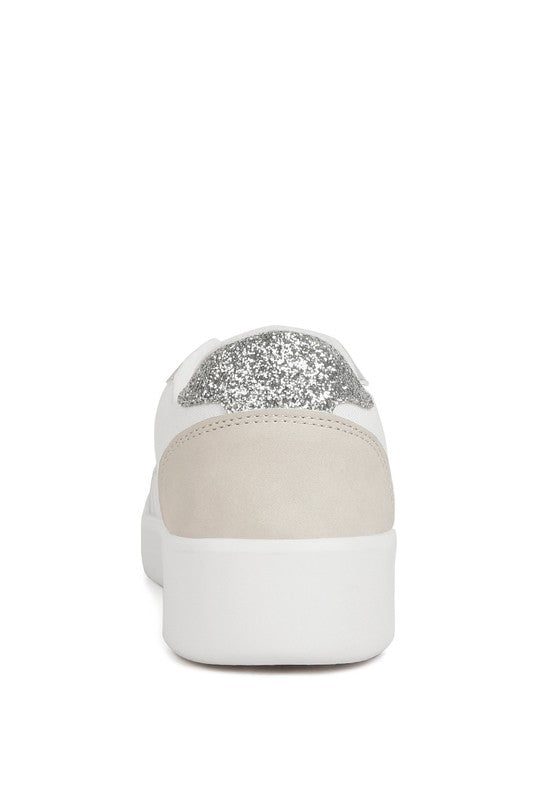 Back view of white Perry sneakers with beige panels and silver glitter heel accent