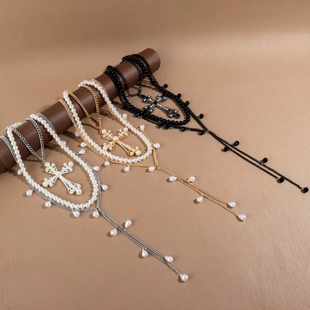 Pearl cross pendant necklace set with layered white pearls and gold/silver-tone chain styles