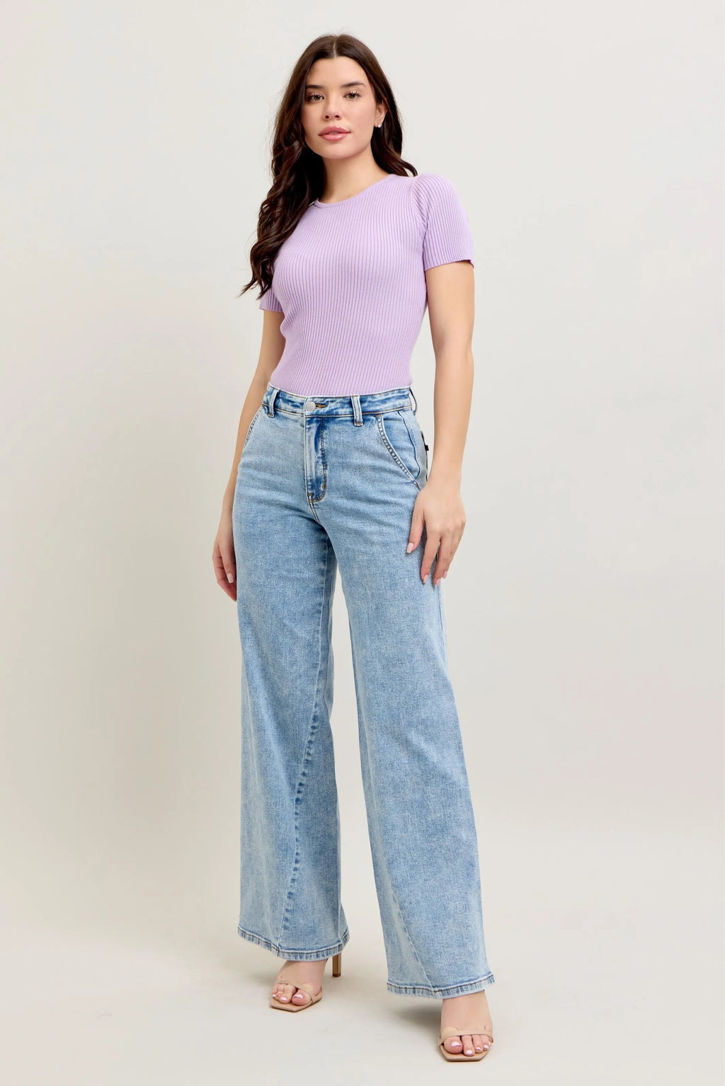 Light wash high-waist wide-leg jeans on model, front view with stitched seams
