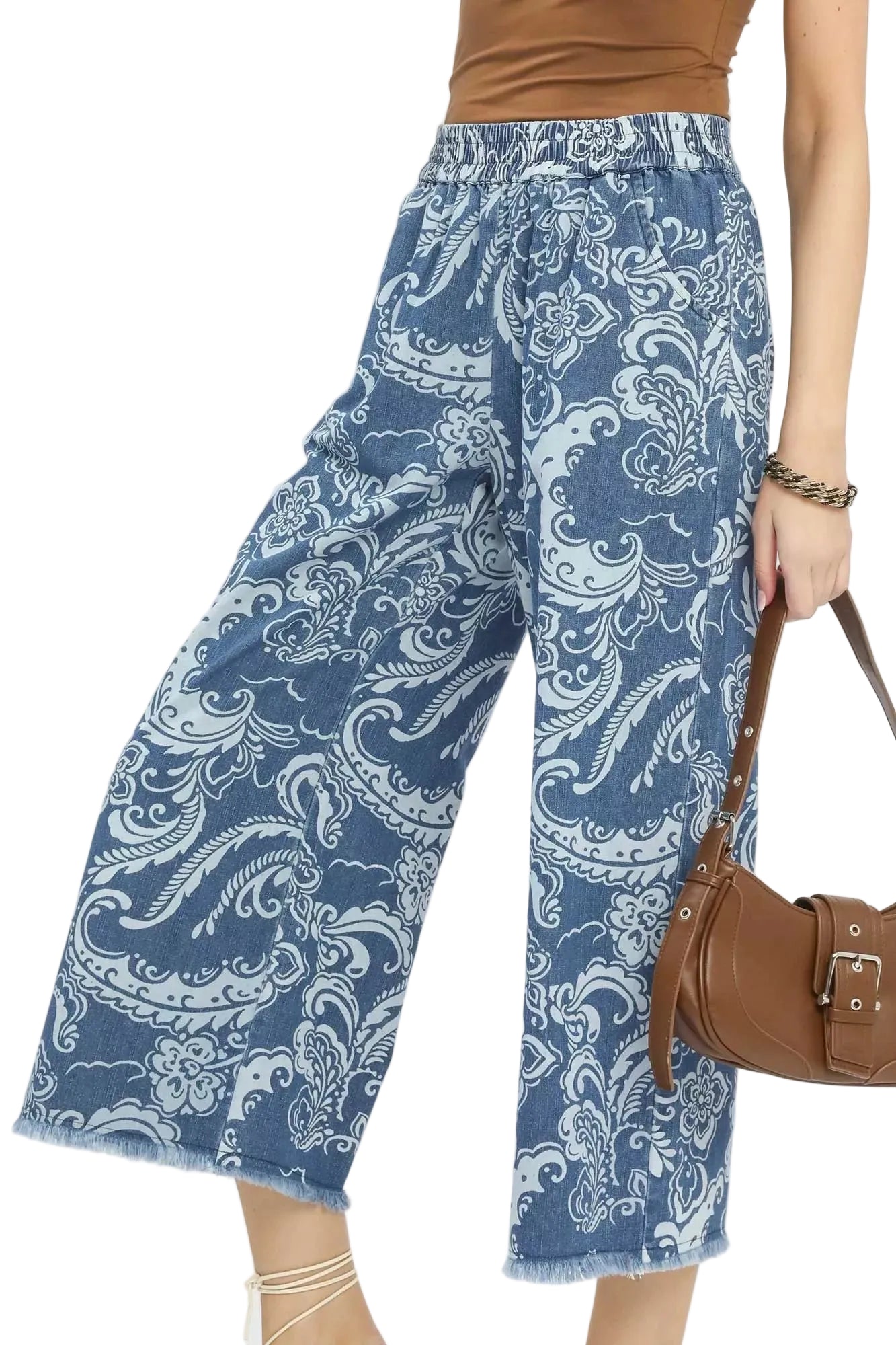 Wide-leg crop pants in denim blue with white paisley pattern and frayed cuffs