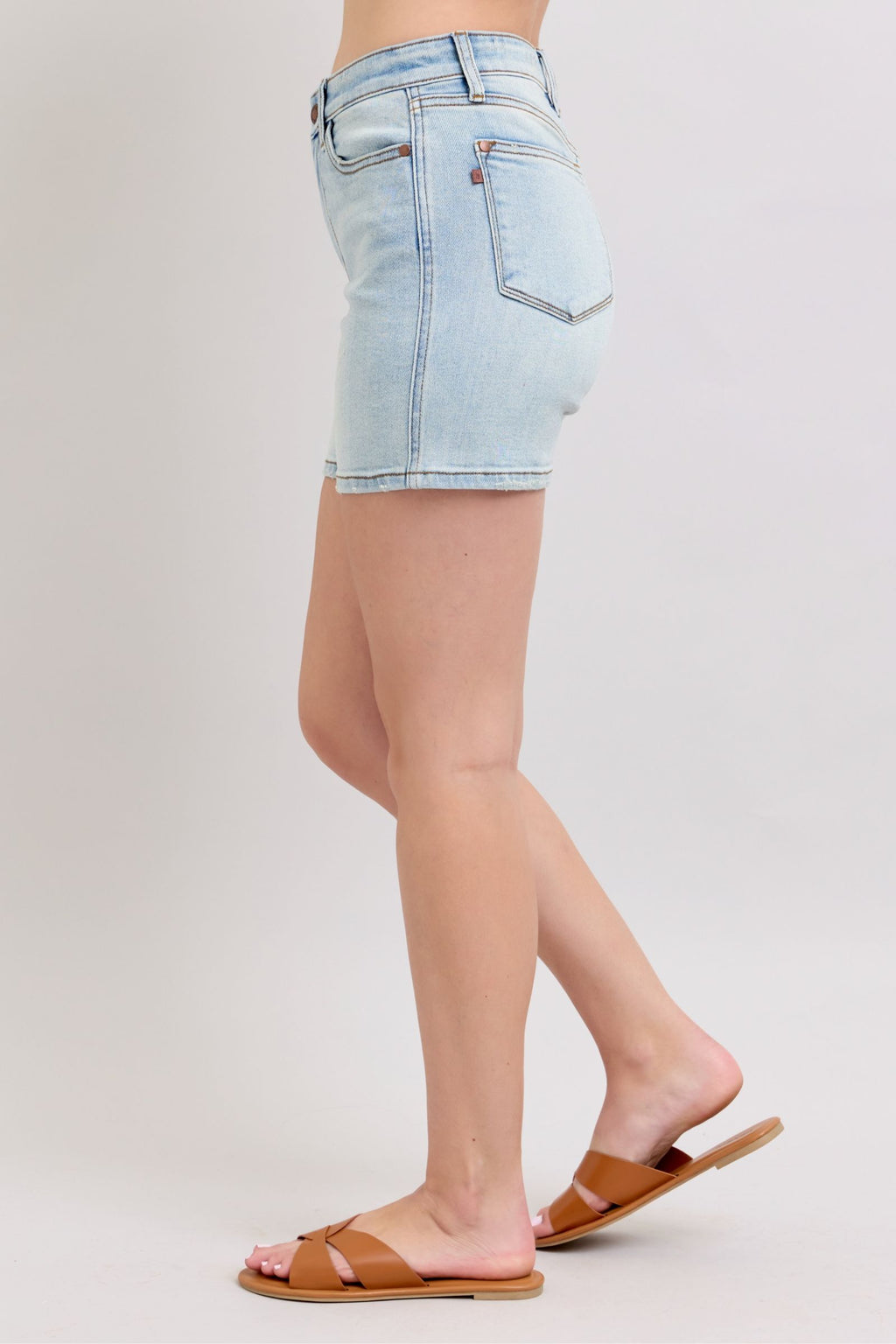 Light-wash denim shorts back view with two rear pockets and straight hem