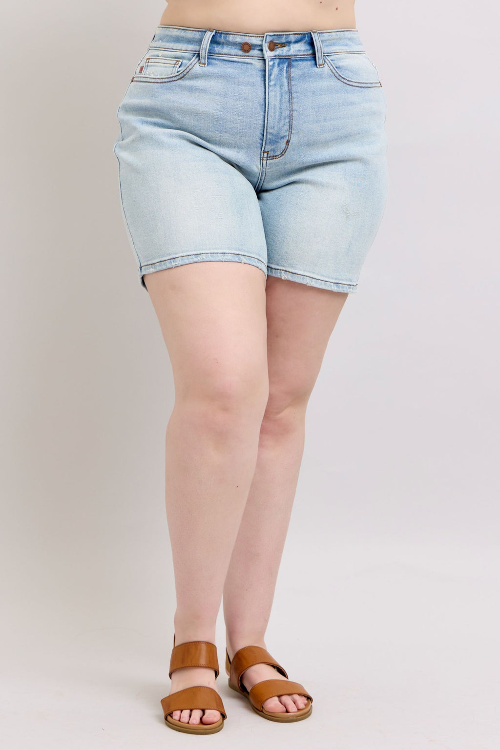 Light-wash denim shorts, back view with waistband detail and pockets