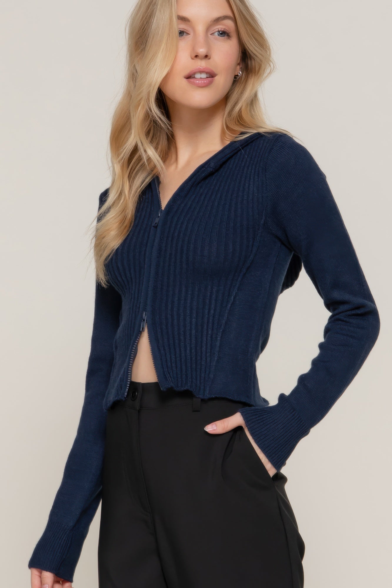 Navy ribbed knit zip-up sweater hoodie, hood and cuffs visible