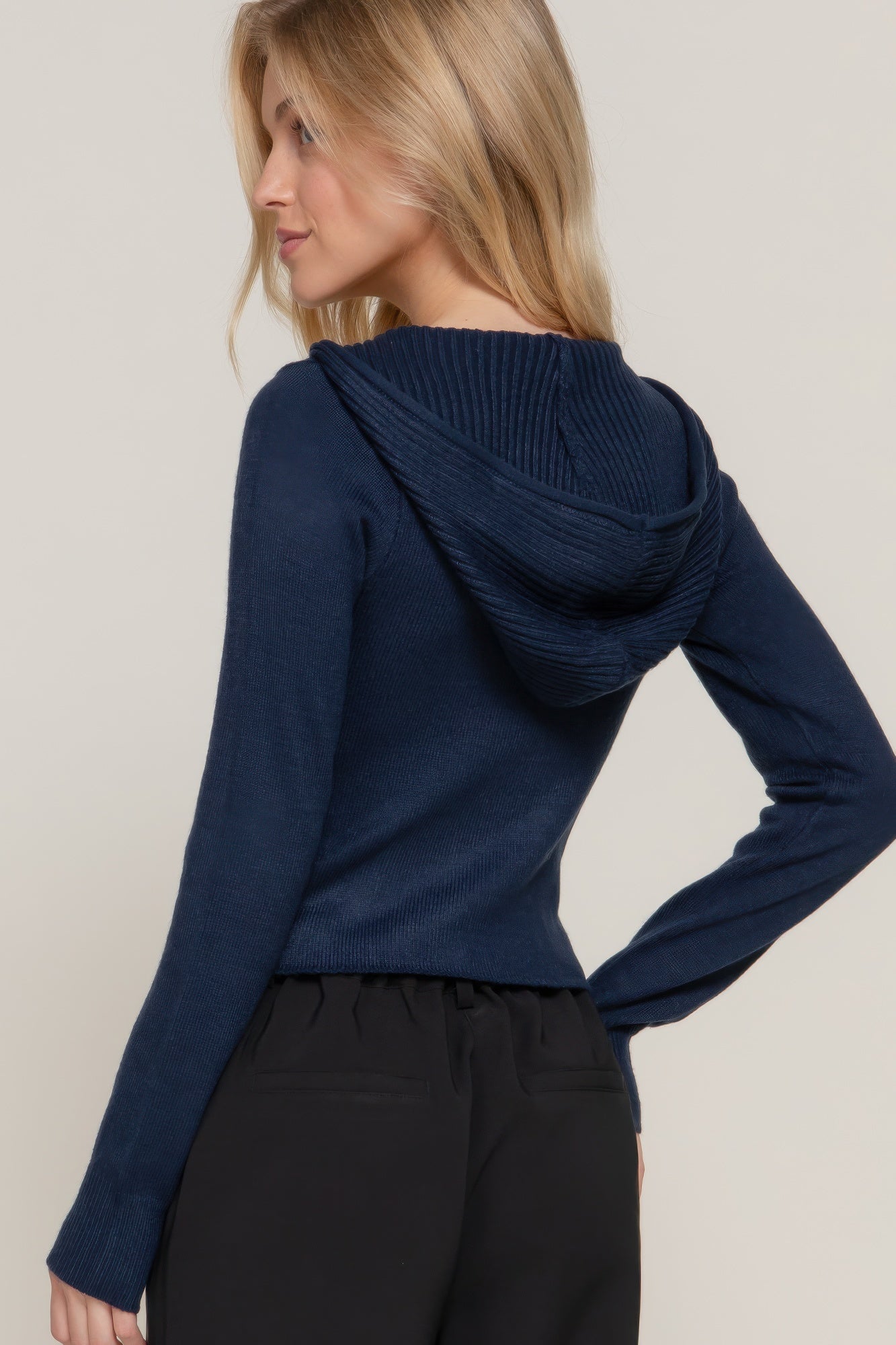 Navy ribbed sweater hoodie back view with hood, long sleeves and curved hem