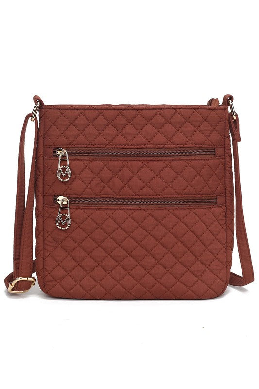 Quilted cotton crossbody bag in brown with two front zip pockets and adjustable shoulder strap