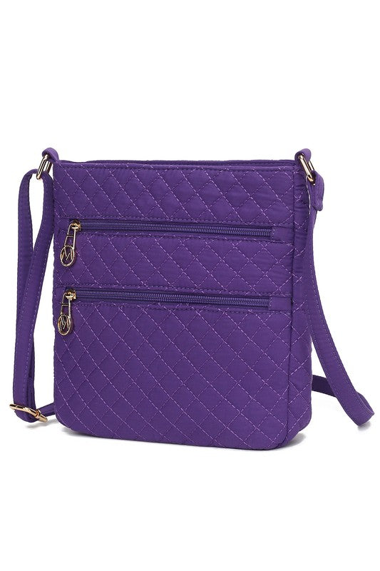 Quilted cotton crossbody bag in purple with two front zip pockets and side strap hardware
