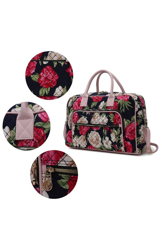 Close-up of botanical duffle bag details: rose print, handles, front zipper, logo charm