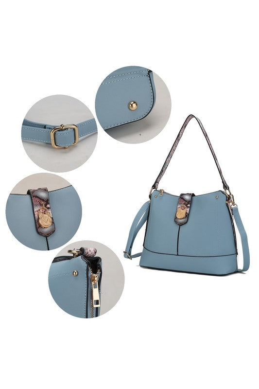 Blue shoulder bag detail: snap closure, gold grommets, and snake-pattern front tab panel