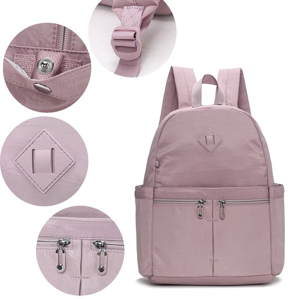 Mauve Tatum backpack details: logo badge, zipper pulls, and strap attachment