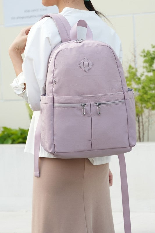 Mauve Tatum backpack worn on back with two front zips and adjustable straps