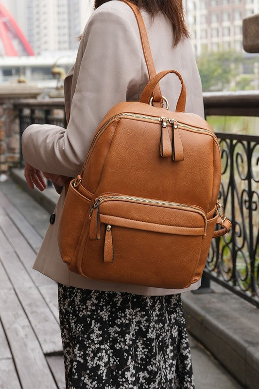 Convertible backpack in Dusty Pink, top handle and front zip pockets, small bag size