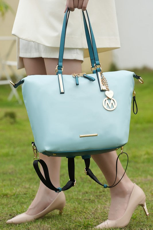 Light blue MKF Layla solid tote backpack with teal handles and M charm