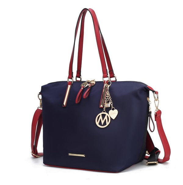 Navy tote backpack with red handles and gold-tone M charm, side strap visible
