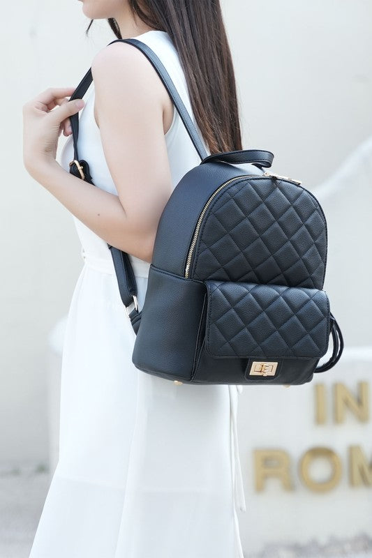 Quilted black mini backpack with front flap, gold buckle, and zip top