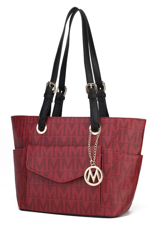 Burgundy tote bag with black leather straps, flap pocket, and M charm