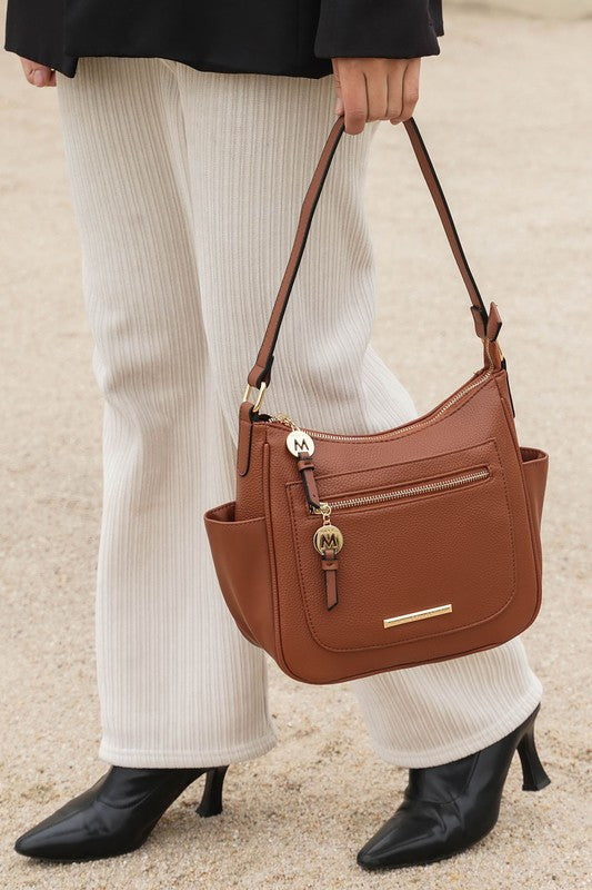 Wally shoulder bag in brown with front zip pocket, gold bar detail, and adjustable strap