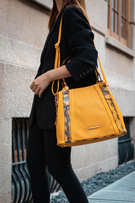 Mustard Kenna tote with snake-embossed trim, structured body, and front bar clasp.