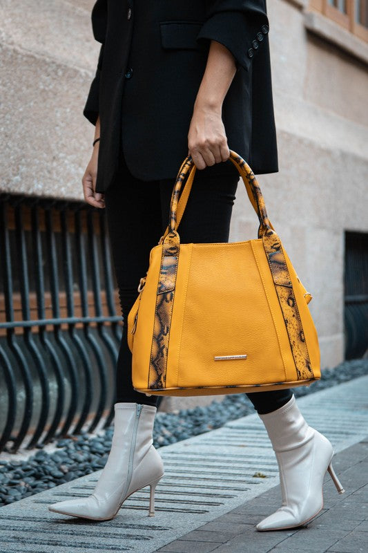 Mustard tote bag with snake-embossed side panels and top handles.