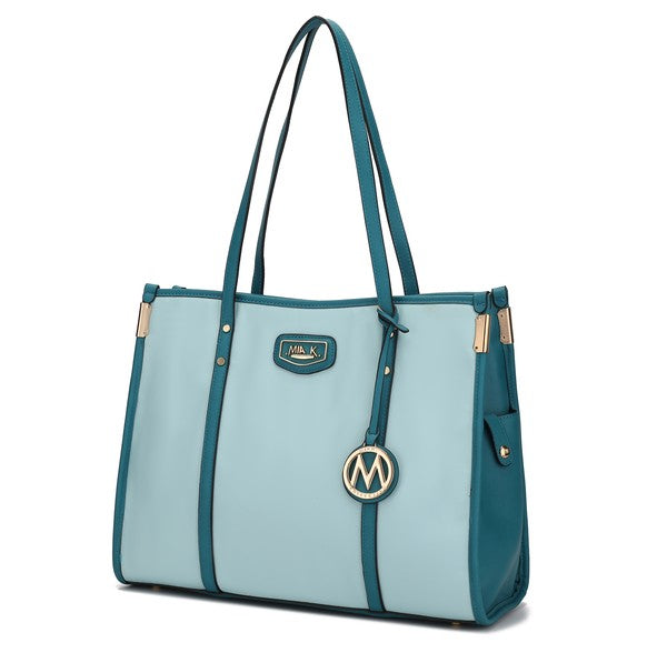Oversize tote in teal with long handles, front logo patch, and circular M charm