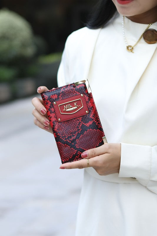 Wine snake-print zip wallet and card case held in hands