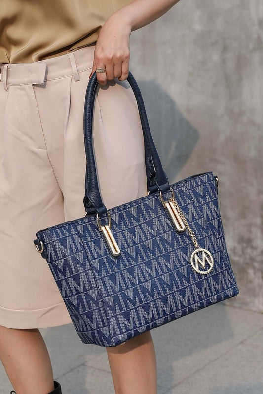 Navy patterned tote with attached pouch, dual handles, and circular MKF logo charm