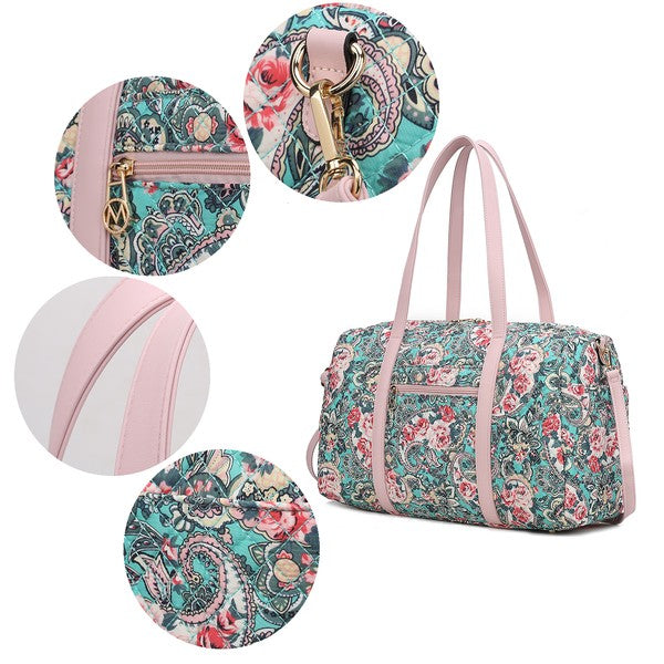 Detail view of quilted duffle bag: light pink handles, patterned fabric, gold-tone hardware