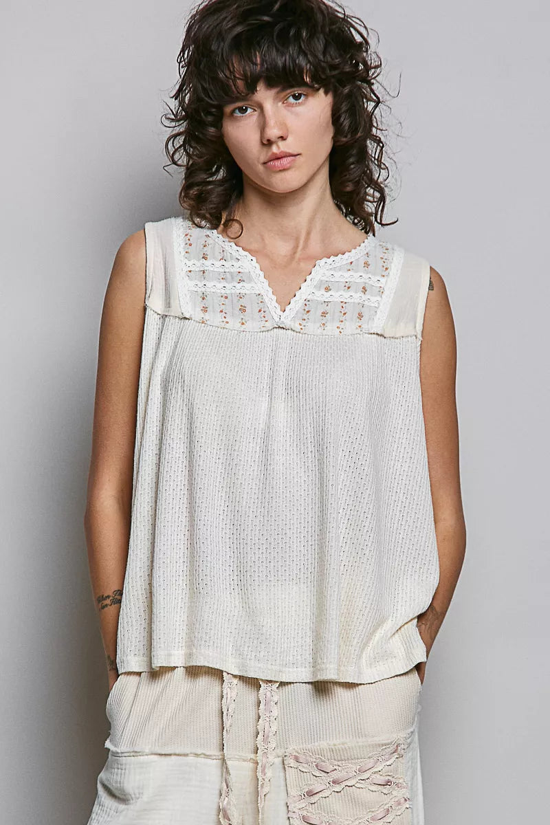 Natural sleeveless top with floral lace V-neck yoke and double-gauze bodice