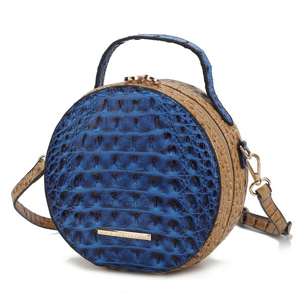 Navy croc-embossed round crossbody bag with contrasting tan trim and strap