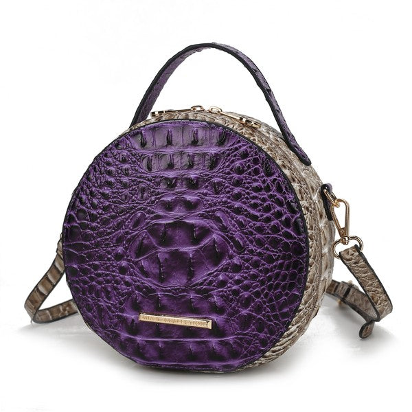 Purple croc-embossed round crossbody bag with gold zipper detail and strap