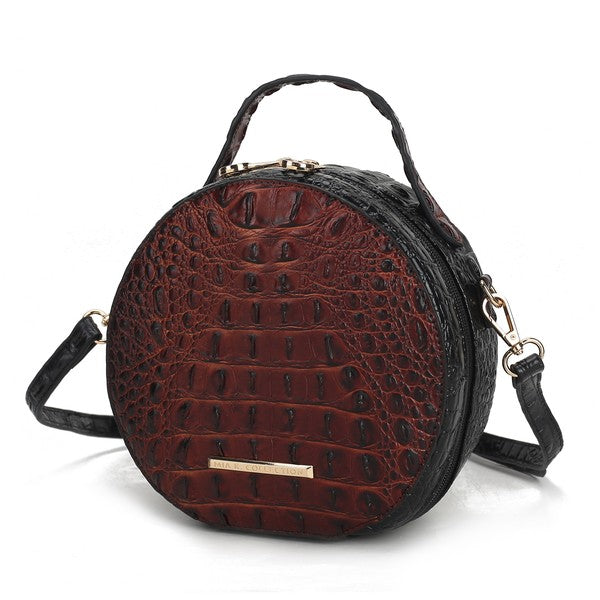 Red croc-embossed round crossbody bag with black trim and gold front plaque