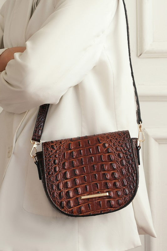 Brown croc-embossed crossbody bag with adjustable strap and front flap