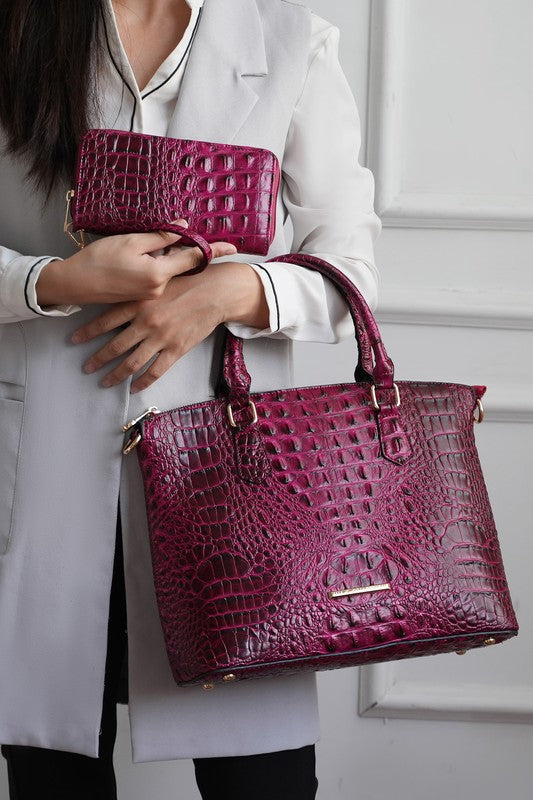 Fuchsia croc-embossed tote with mini pouch, top handles, gold-tone hardware.