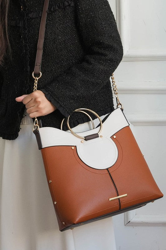 Cognac leather top handle satchel with white front panel and gold-tone hardware.