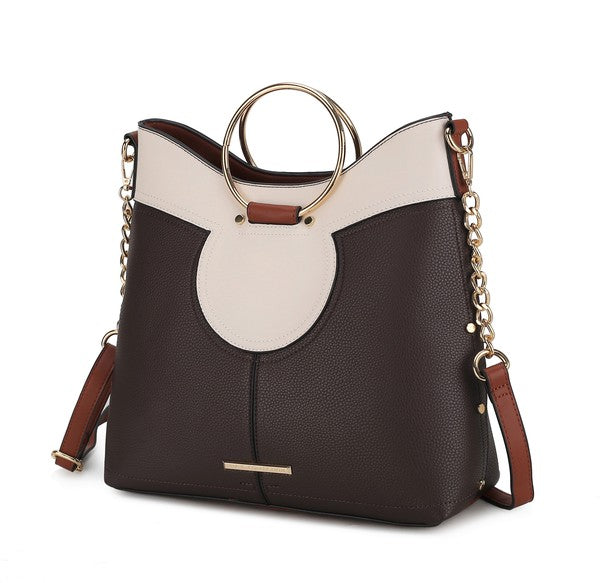 Chocolate brown and white top handle satchel with oval front cutout and side strap.