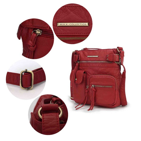 Burgundy crossbody bag close-up: logo patch, zippers, buckle strap, tassel pulls