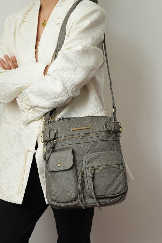 Grey crossbody bag with front zip compartments and adjustable crossbody strap