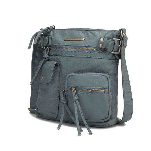 Denim blue crossbody bag with front zip pocket, tassel pulls, and adjustable strap