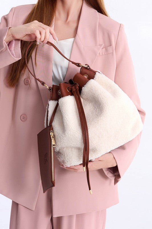 Brown sherpa bucket bag with top drawstring and hanging zipper pouch detail