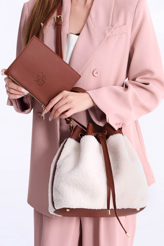 Brown Saryn bucket bag with gold zipper and adjustable drawstring cords