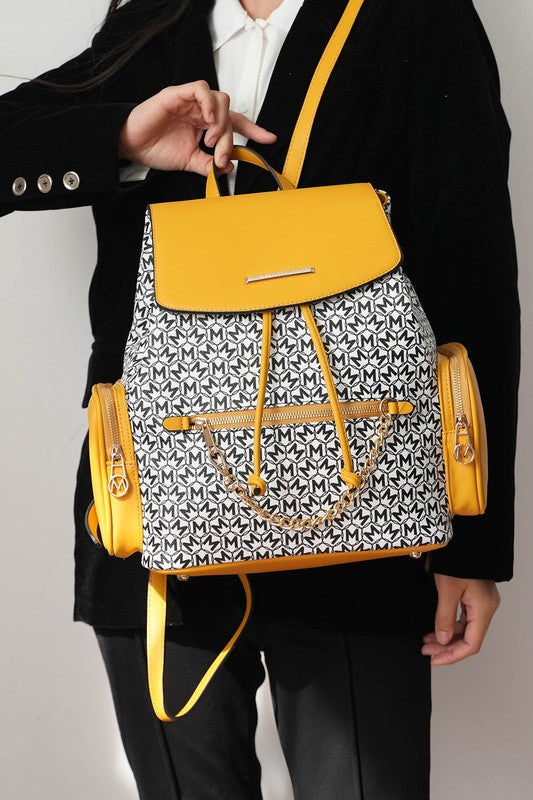 Mustard-accent Issah backpack on model, patterned front with drawstring and adjustable straps