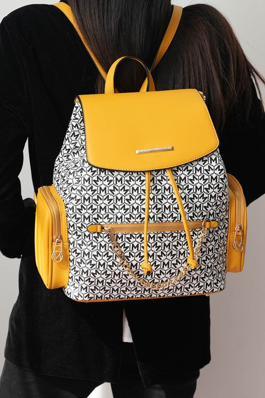 Mustard MKF Issah backpack with patterned body, flap pocket, and side zip pouch