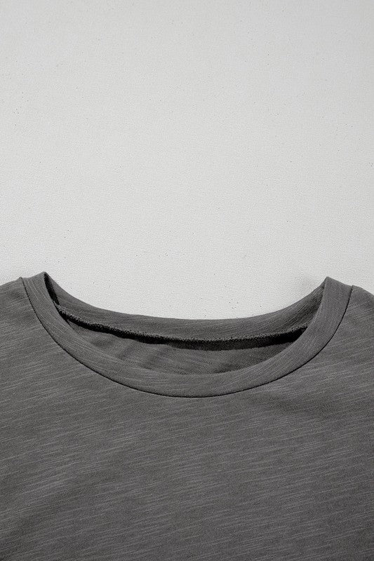 Dark Grey crew neckline of plain blouse with ruffle-sleeve detail, close-up