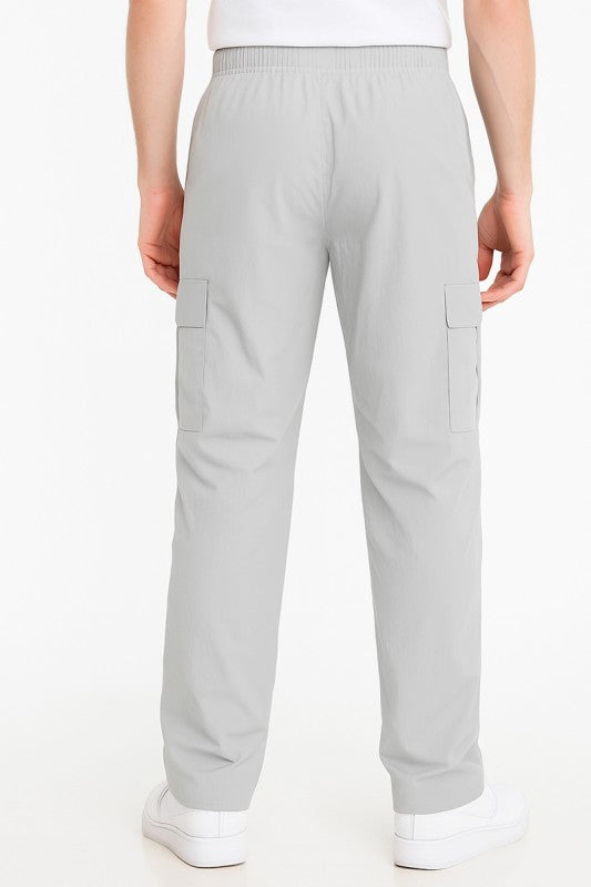 Light grey nylon cargo pants with cargo pockets and elastic waistband
